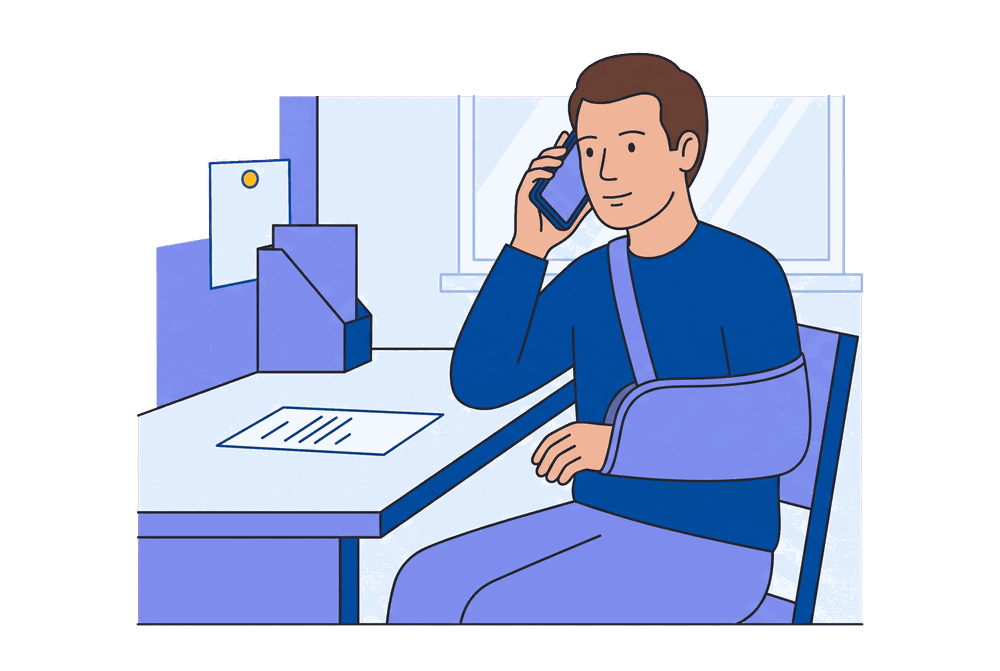 A man on the phone at his desk, a walking stick resting beside him