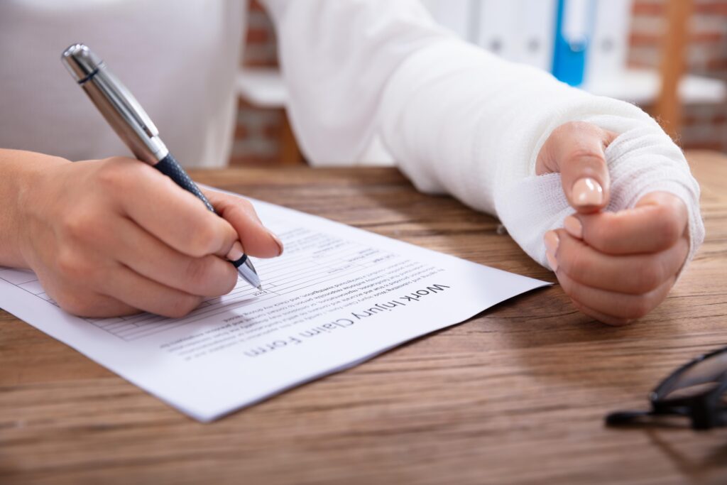 Injured Woman Filling Work Injury Claim Form
