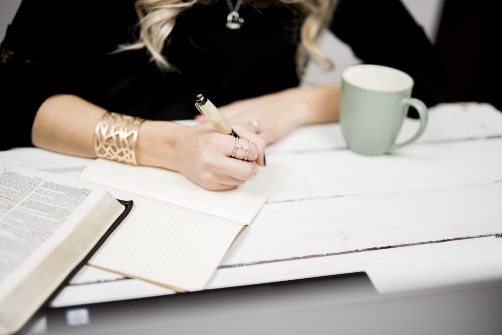 closeup shot of a person taking notes off of a book