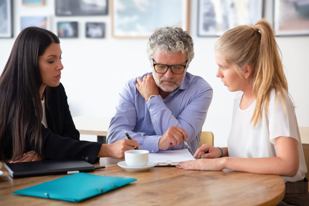 Family legal advisor explaining document details to mature father and adult