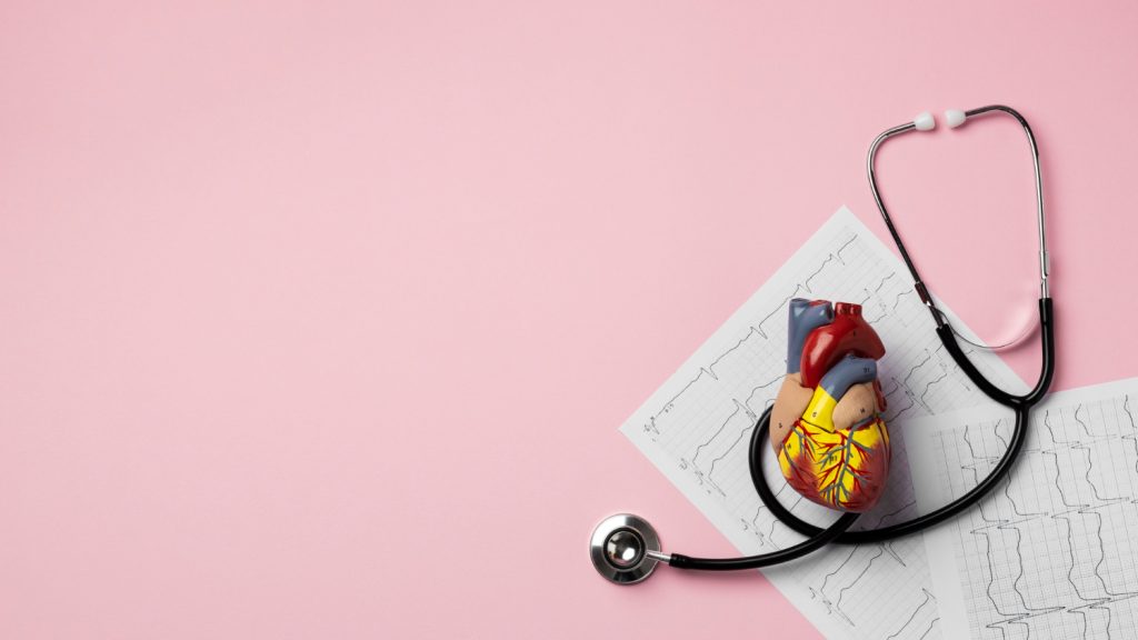 A stethoscope and heart on a pink background, symbolizing the TPD Helpline's focus on health and support.